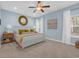 Relaxing primary bedroom showcases soft blue walls, neutral carpet, and a king bed with luxurious throw pillows at 309 Lake Mist Ct. # 309, Longs, SC 29568