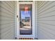 Front door with decorative glass and sidelights, adorned with a festive wreath at 309 Lake Mist Ct. # 309, Longs, SC 29568