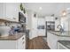 Bright kitchen featuring granite countertops, stainless steel appliances, and white cabinetry at 309 Lake Mist Ct. # 309, Longs, SC 29568