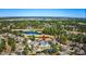 Wide aerial shot of a lovely white brick home near a green golf course and several bodies of water at 3100 Lahinch Dr., Myrtle Beach, SC 29579