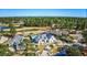 Aerial view of a home with a pool and golf course in a lush, wooded community at 3100 Lahinch Dr., Myrtle Beach, SC 29579