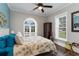 Cozy bedroom featuring blue accents, arched window for natural light, and dark wood flooring at 3100 Lahinch Dr., Myrtle Beach, SC 29579