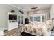 Comfortable bedroom with a floral bed set, built-in cabinet, French doors and bright bay window with a scenic view at 3100 Lahinch Dr., Myrtle Beach, SC 29579
