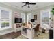 Bright home office with a modern desk, built-in shelving, and abundant natural light from multiple windows at 3100 Lahinch Dr., Myrtle Beach, SC 29579