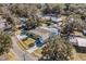 Aerial view of the property showcasing a spacious lot, manicured lawn, in-ground pool, and mature trees at 321 Jay St., Murrells Inlet, SC 29576