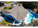 Aerial view of a charming house with a gray roof, a backyard pool, lounge chairs, and a white fence at 321 Jay St., Murrells Inlet, SC 29576