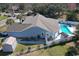 Aerial view of a blue home with a backyard pool, shed, fenced yard, and landscaped lawn at 321 Jay St., Murrells Inlet, SC 29576