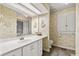 A bathroom with plenty of cabinets and counter space is accentuated with decorative wallpaper at 321 Jay St., Murrells Inlet, SC 29576
