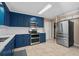 Contemporary kitchen featuring stainless steel appliances and striking blue cabinets at 321 Jay St., Murrells Inlet, SC 29576