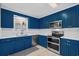 Updated kitchen with stainless appliances, white countertops, and stylish blue cabinetry at 321 Jay St., Murrells Inlet, SC 29576