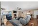 Bright living room with hardwood floors, a stone fireplace, and access to a blue-themed kitchen and dining area at 321 Jay St., Murrells Inlet, SC 29576