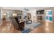 Cozy living room boasting hardwood floors, a stone fireplace, and an open-concept design at 321 Jay St., Murrells Inlet, SC 29576