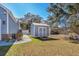 Backyard shed featuring a charming design, well-kept lawn, and mature trees perfect for extra storage at 321 Jay St., Murrells Inlet, SC 29576