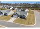 Aerial view of a single-Gathering home in a neighborhood with well-manicured lawns and tree-lined streets at 351 Lakota Loop, Longs, SC 29568