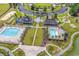 Overhead view of community amenities, highlighting pools, clubhouse, and playground near the lake at 3600 White Wing Circle, Myrtle Beach, SC 29579