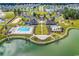 Aerial view showcasing the community's pool, clubhouse, and recreational areas by the lake at 3600 White Wing Circle, Myrtle Beach, SC 29579