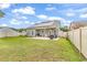 Spacious backyard with well-kept lawn, patio area, fenced perimeter, and solar panels on roof at 3600 White Wing Circle, Myrtle Beach, SC 29579