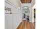 Inviting hallway featuring hardwood floors, decorative wall panels, and a rustic wood ceiling accent at 3600 White Wing Circle, Myrtle Beach, SC 29579