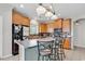 Well-lit kitchen featuring wood cabinets, tile backsplash, and an island with bar stool seating at 3600 White Wing Circle, Myrtle Beach, SC 29579