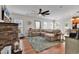 Bright living room features a stone fireplace, hardwood floors, and a comfortable sectional sofa at 3600 White Wing Circle, Myrtle Beach, SC 29579