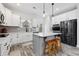 Modern kitchen featuring stainless steel appliances, white cabinets, gray backsplash, and an island with bar stool seating at 395 Dunbarton Ln., Conway, SC 29526