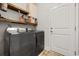 Modern laundry room with front-loading washer/dryer and shelving at 395 Dunbarton Ln., Conway, SC 29526