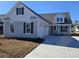 Charming home featuring a two-car garage, complemented by a well-manicured lawn at 410 Starlit Way, Myrtle Beach, SC 29579