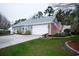 Home with a two car garage, American flag and a beautiful landscaped yard at 4228 Highway 1008, Little River, SC 29566