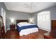 Spacious main bedroom with hardwood floors, tray ceilings, and shuttered windows, filled with natural light at 4228 Highway 1008, Little River, SC 29566