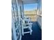 Relaxing balcony with white Adirondack chairs and views of the surrounding landscape at 4519 N Plantation Harbour Dr. # X - 19, Little River, SC 29566