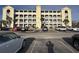 View of parking lot and building, featuring balconies and light yellow accents at 4519 N Plantation Harbour Dr. # X - 19, Little River, SC 29566