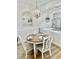 Charming dining area with a round table, white chairs, and a decorative chandelier at 4519 N Plantation Harbour Dr. # X - 19, Little River, SC 29566