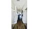 Long hallway with hardwood floors, white walls, and views into the living space at 4519 N Plantation Harbour Dr. # X - 19, Little River, SC 29566