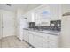 Well-lit kitchen with a window, tile backsplash, double sink, and modern white appliances at 453 Saint Charles Circle, Myrtle Beach, SC 29588