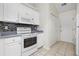 Bright kitchen features white appliances, mosaic backsplash, tile floors and generous counter space at 453 Saint Charles Circle, Myrtle Beach, SC 29588