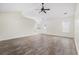 Spacious living room featuring wood-look flooring, ceiling fan, and abundant natural light at 453 Saint Charles Circle, Myrtle Beach, SC 29588