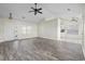 Bright living room with wood-look flooring, ceiling fan, and open layout, leading into the kitchen at 453 Saint Charles Circle, Myrtle Beach, SC 29588