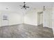 Airy living room with vaulted ceiling, wood-look flooring, and a door leading to the backyard at 453 Saint Charles Circle, Myrtle Beach, SC 29588