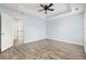 Bright main bedroom with laminate flooring and open door to the ensuite bathroom at 453 Saint Charles Circle, Myrtle Beach, SC 29588