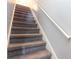 Carpeted stairs with a white handrail leading to the upper level at 4584 Lomax Ct. # 1B, Murrells Inlet, SC 29576