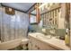 Vintage bathroom with green tile, shower and tub combination, and traditional fixtures at 4810 Circle Dr., Loris, SC 29569