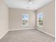 Bedroom with neutral walls, carpeted flooring, ceiling fan and two windows at 4936 Crab Pond Ct. # 201, Myrtle Beach, SC 29579