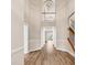 Stunning two-story foyer showcasing a beautiful chandelier, hardwood floors, and elegant staircase at 4936 Crab Pond Ct. # 201, Myrtle Beach, SC 29579