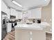 Modern kitchen featuring white cabinets, stainless steel appliances, and countertop seating area at 4936 Crab Pond Ct. # 201, Myrtle Beach, SC 29579