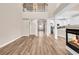 Open-concept living room with a fireplace, high ceilings, and seamless flow to the kitchen at 4936 Crab Pond Ct. # 201, Myrtle Beach, SC 29579