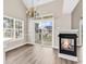 Cozy living room with vaulted ceiling, fireplace and chandelier, and sliding glass doors leading to balcony at 4936 Crab Pond Ct. # 201, Myrtle Beach, SC 29579