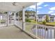 Screened patio with serene views of lush landscaping and a tranquil pond at 4936 Crab Pond Ct. # 201, Myrtle Beach, SC 29579
