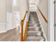 Carpeted staircase with stained wood railings leads to the upper level at 4936 Crab Pond Ct. # 201, Myrtle Beach, SC 29579
