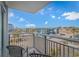 Charming balcony view overlooking the street with palm trees and nearby building and parking at 504 N Ocean Blvd. # 310, Myrtle Beach, SC 29577