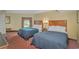 Comfortable bedroom featuring two queen beds with blue comforters, side tables, and warm lighting at 504 N Ocean Blvd. # 310, Myrtle Beach, SC 29577